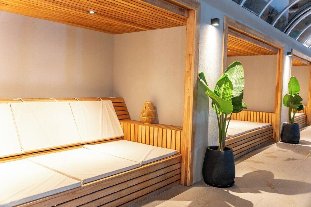 Sector de descanso con banco de madera, plantas y claraboya
