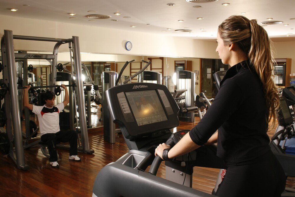 Gimnasio con cinta de correr y máquinas de pesas